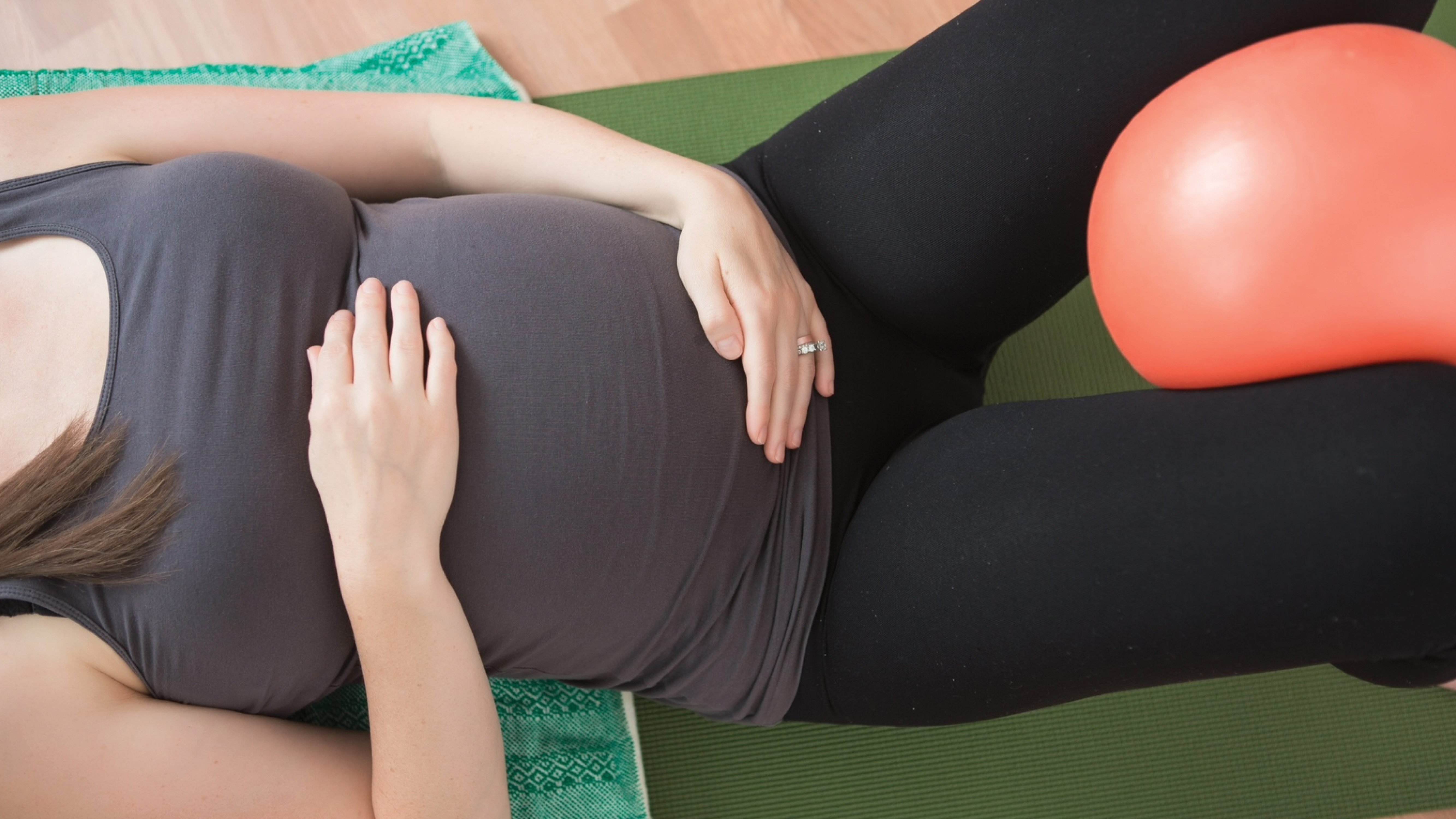 Pregnant woman on mat for pelvic floor physical therapy