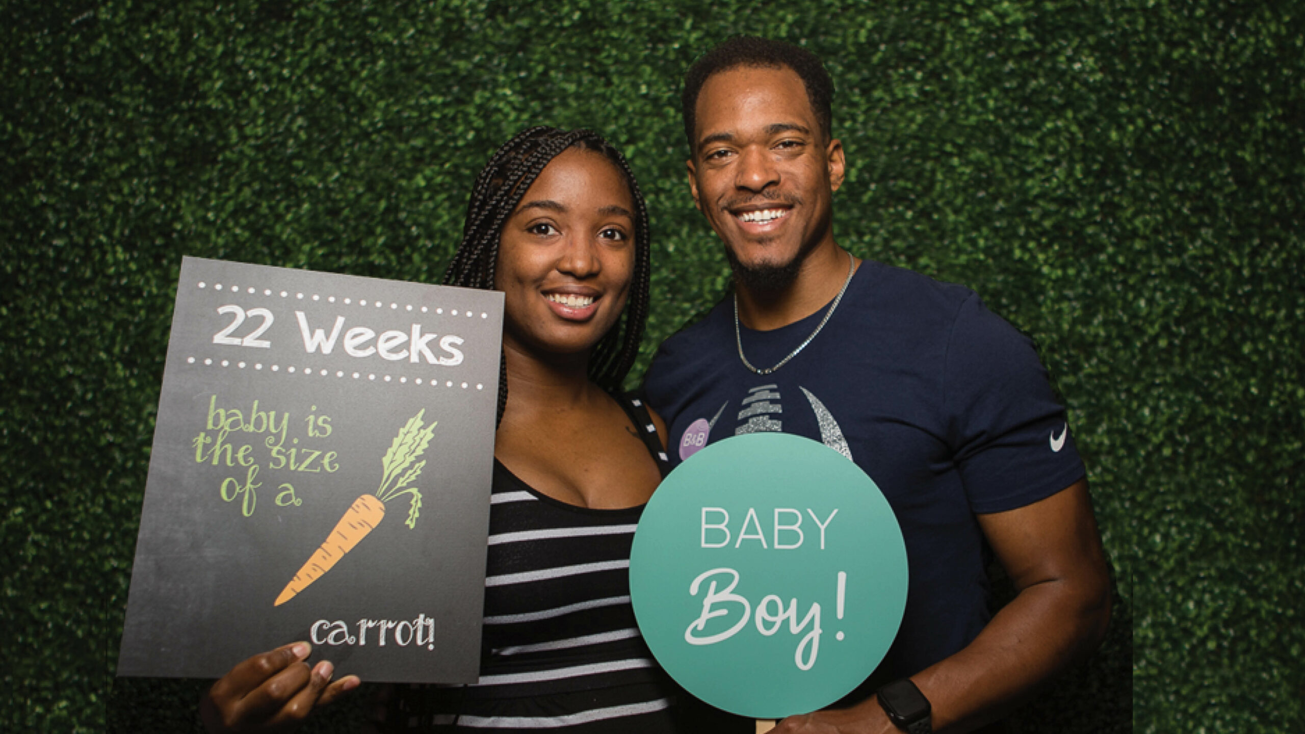 Couple in photo booth at Babies & Bumps event