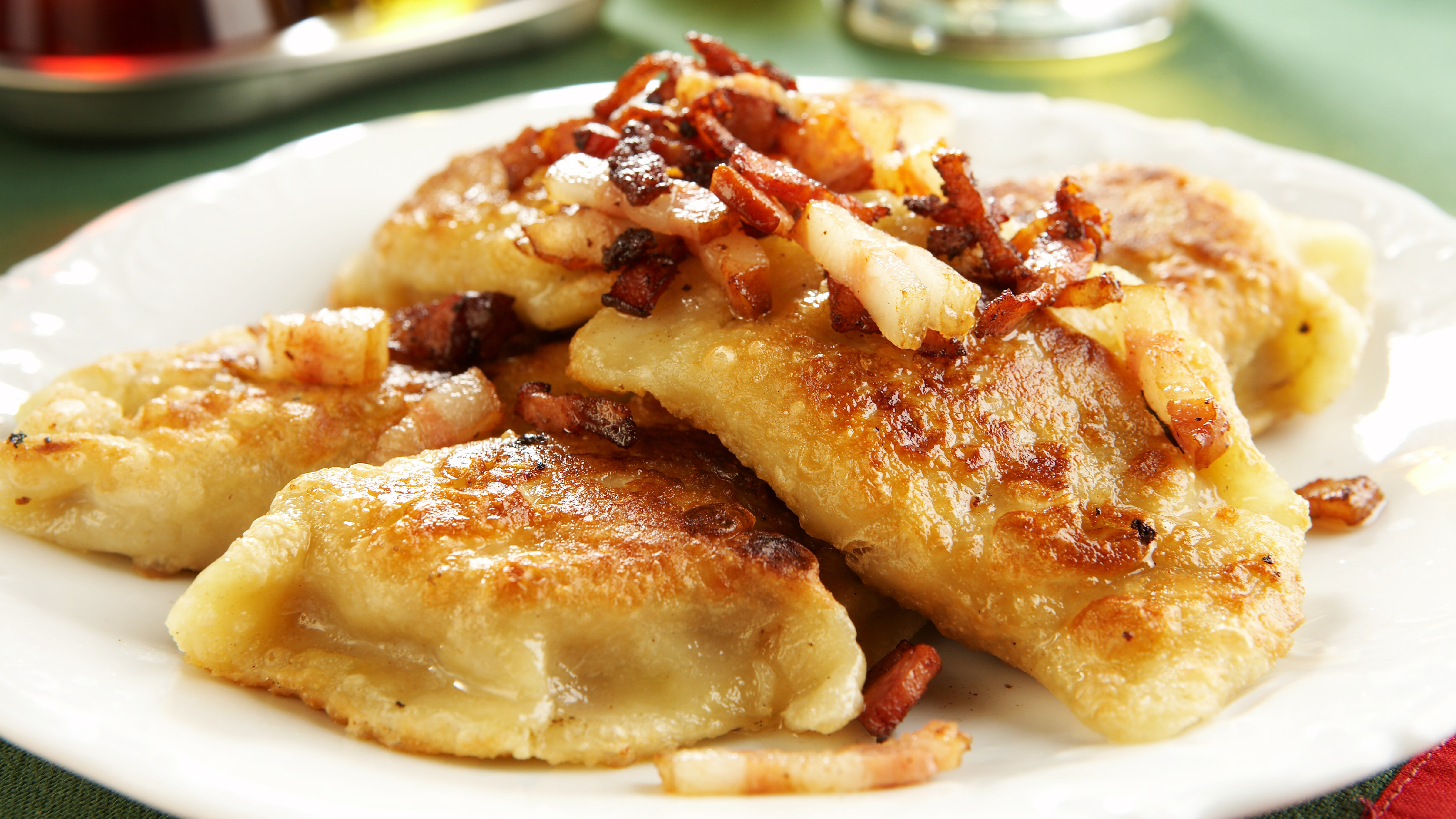 Pierogies with bacon and onions on a plate.