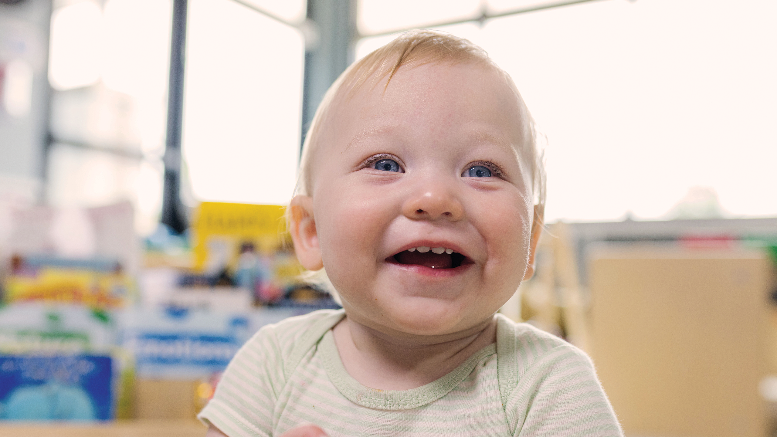 Smiling toddler at daycare.